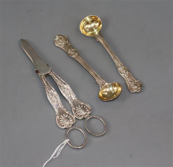 A pair of silver grape shears, Sheffield, 1959 and a pair of Victorian silver mustard spoons.